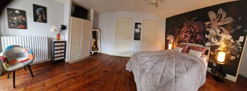 a bedroom with a bed and a wooden floor at Les GARGOUILLES Gorges du Tarn - Millau in Boyne