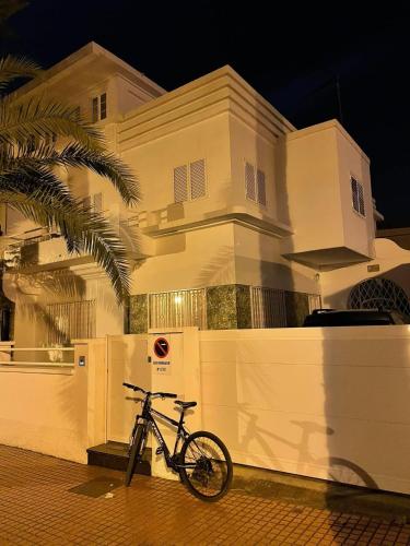 a bike parked in front of a white building at Nomad Villa Santa Fe in Las Palmas de Gran Canaria