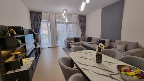 a living room with a table and a couch at Two bedroom Apartment Muscat Bay in Muscat