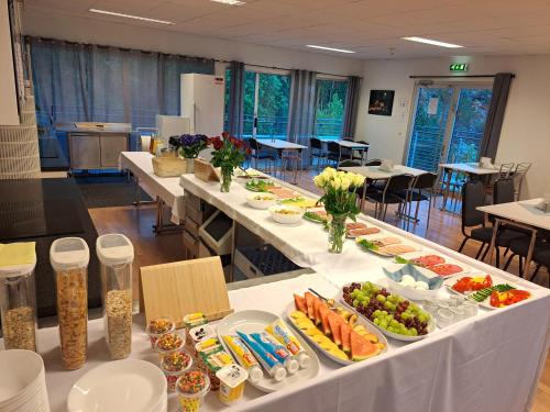 a table with many plates of food on it at Motell Svinesundparken in Halden