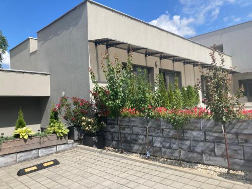 a house with flowers and plants on a wall at Apartmány I - KAfe Bojnice in Bojnice