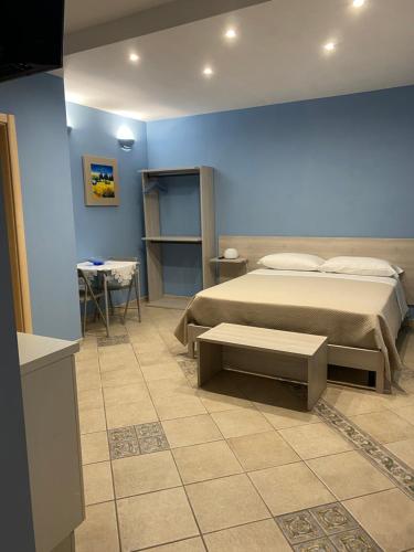 um quarto com uma cama e uma parede azul em Villa Vittoria em Matera