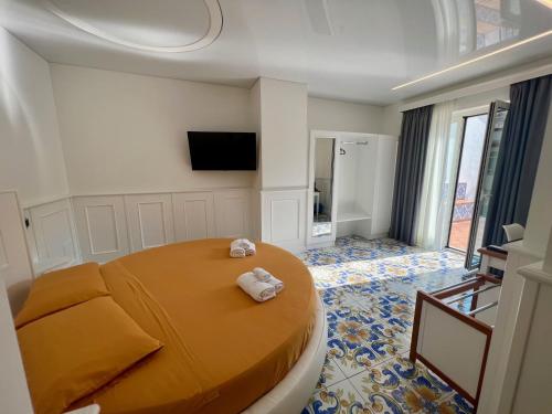 a bedroom with a large bed with towels on it at TEA Luxury - Praia a Mare in Praia a Mare