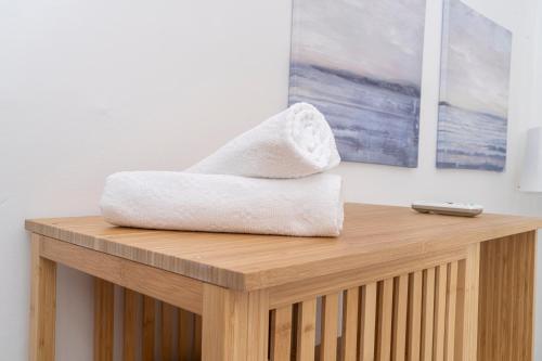 a towel sitting on top of a wooden table at Private room in shared flat in Nicosia