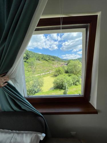 a window with a view of a green field at Ski eden in Mýto pod Ďumbierom
