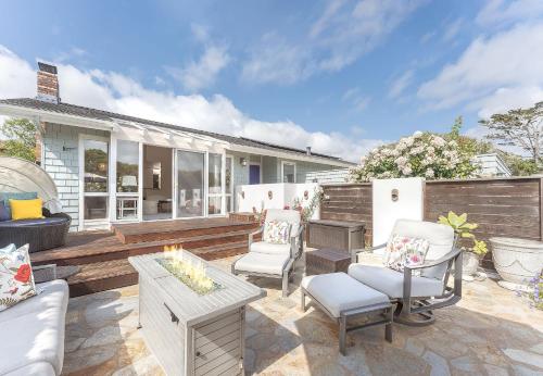 a patio with chairs and a table and a fireplace at 3897 Driftwood home in Carmel