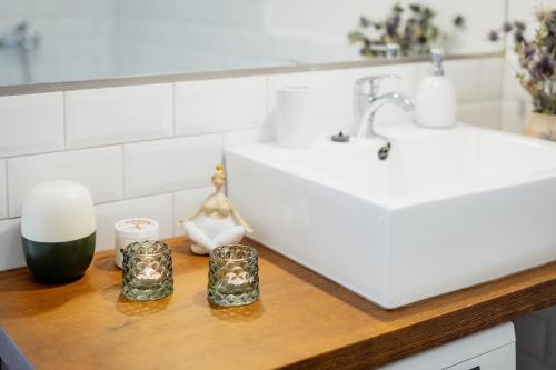 a bathroom counter with two candles and a sink at Luxury apartment close to the sea in Kuressaare