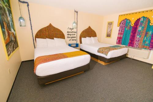 a hotel room with two beds in a room at Riverside Inn in Cold Spring