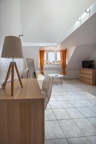 un salon avec un lit et une table dans l'établissement Le Saint Rémy, à Dieppe