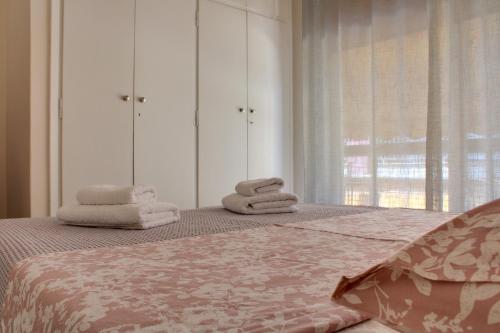 a bedroom with a bed with towels on it at Modern Cozy Apartment in Downtown Athens in Athens