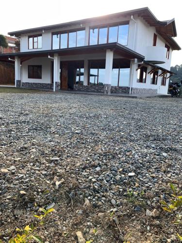 a house with a large gravel yard in front of it at Hermosa vista GH #4 in Guarne