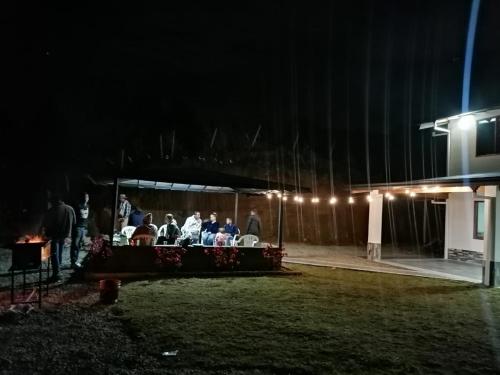 un grupo de personas sentadas en una mesa por la noche en Hermosa vista GH #4, en Guarne