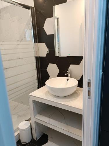 a bathroom with a sink and a mirror and a shower at Casa Sonia in Vadu