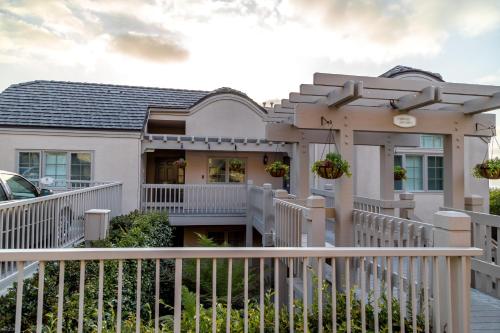 a white fence in front of a house at Villa L'Auberge in San Diego