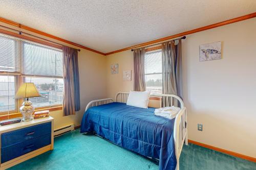 a bedroom with a bed and two windows at Fenwick Town Village --- 606 Coastal Hwy #24 in Fenwick Island