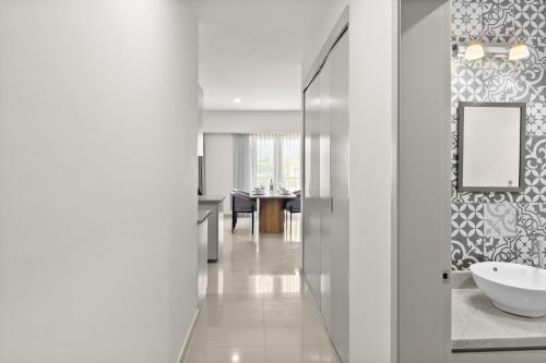 a bathroom with a sink and a mirror at Casa Barros Vacation Condos in Mazatlán