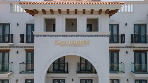 a building with a sign that reads casa barros at Casa Barros Vacation Condos in Mazatlán