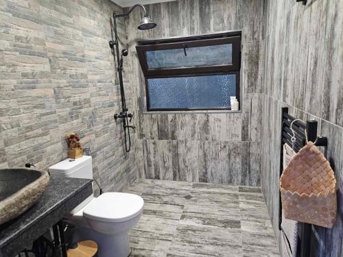a bathroom with a toilet and a sink and a window at Zarevo Glamping in Skobelevo