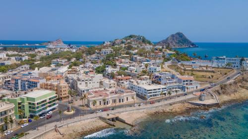 an aerial view of a town on a hill next to the ocean at Casa Barros Vacation Condos in Mazatlán