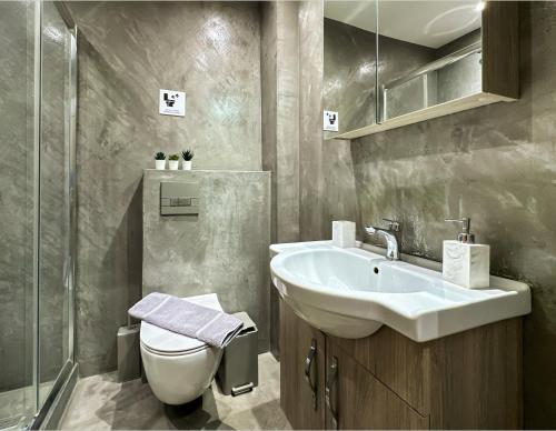 a bathroom with a sink and a toilet at Raise Thessaloniki Urban Stay in Thessaloniki