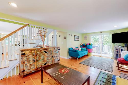 a living room with a staircase and a blue couch at The Lakeside Landing in Plymouth