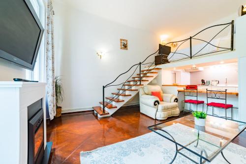 a living room with a glass table and stairs at Sabin Apartments Private Parking in Braşov