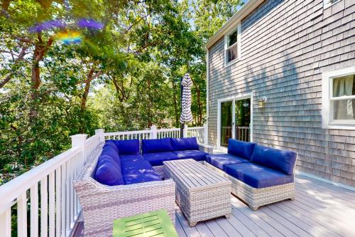 a patio with a blue couch and chairs on a deck at The Lakeside Landing in Plymouth