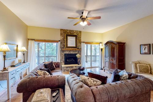 a living room with couches and a ceiling fan at Link Vacation in Whittier