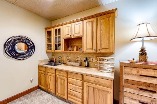 a kitchen with wooden cabinets and a sink at Link Vacation in Whittier