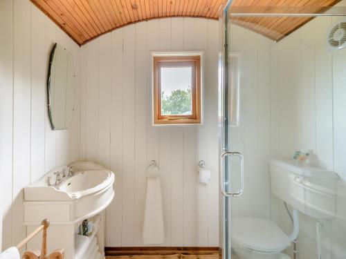 a white bathroom with a sink and a shower at Mahalia in Fordham