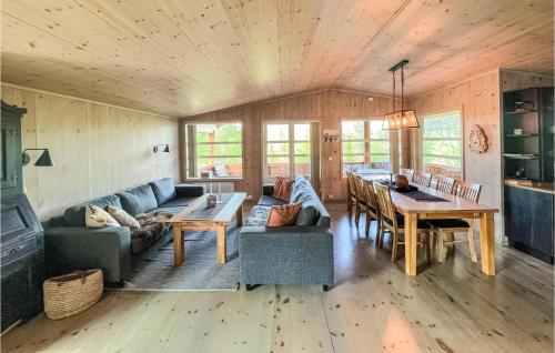 a living room with a couch and a dining room at 4 Bedroom Gorgeous Home In Nord-Torpa in Nord Torpa
