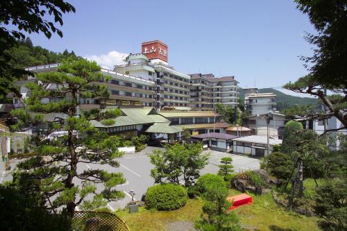 a large building with a courtyard in front of it at Hotel Koyo in Kaminoyama