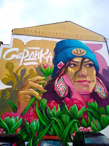 a mural of a woman painted on the side of a building at "Maria Luisa" - Top center apartment in Sofia