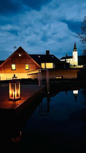 a building with a light in front of a lighthouse at Apartmány NONE in Branná