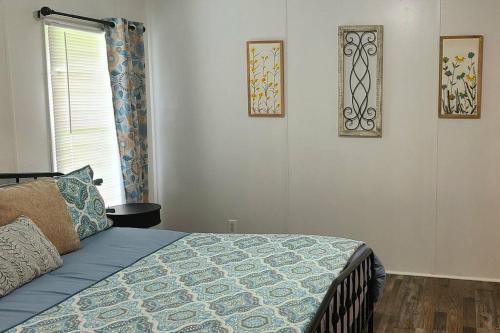 a bedroom with a bed and two pictures on the wall at Cozy Cottage with Full View of the Mountains! in Blue Ridge