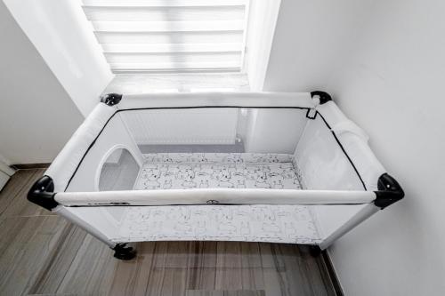a white cart sitting on the floor next to a window at Kenti Residence in Ljubljana