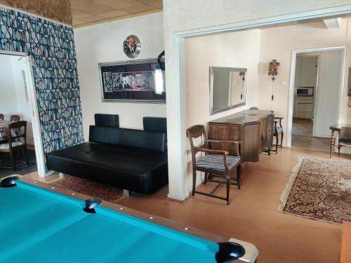 a living room with a pool table at Nina`s GuestHouse, 30m2, 75m2 ja 85m2 tai koko talo 190m2 in Jämsä