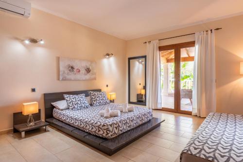 a bedroom with a bed and a bed and a window at Finca Es Figueral in Campos