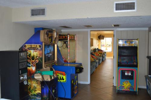 a room with two arcade games and a living room at The Summit Condominiums in Panama City Beach