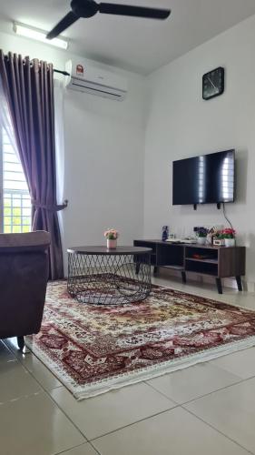 a living room with a table and a tv at Alanis Suite KLIA With Neflix in Sepang
