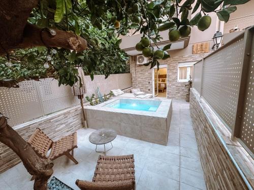 a bathroom with a soaking tub and a tree at Sabbia Mini Pool Suites in Preveza