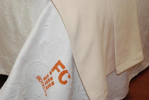 a close up of a white shirt on a bed at Apartahotel FC Catedral in León