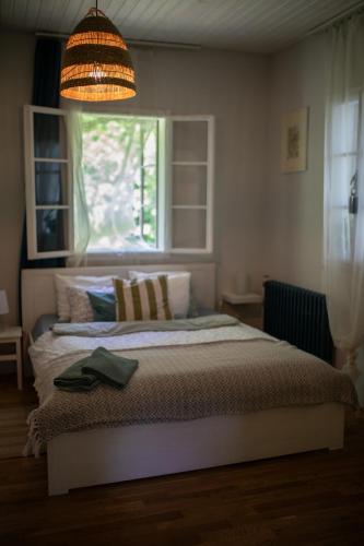 a bedroom with a large bed with a window at Na samotě U Včelína in Lančov