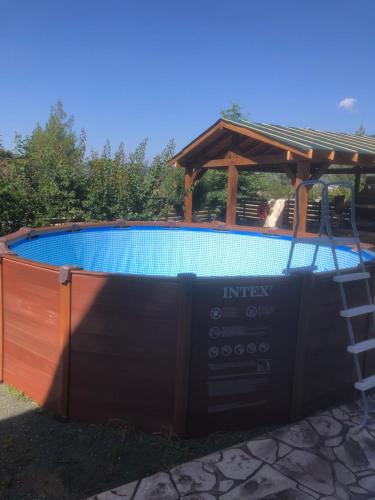 a swimming pool with a gazebo next to a swimming pool at DIAMOND Stone Wooden Guest House in Khandria