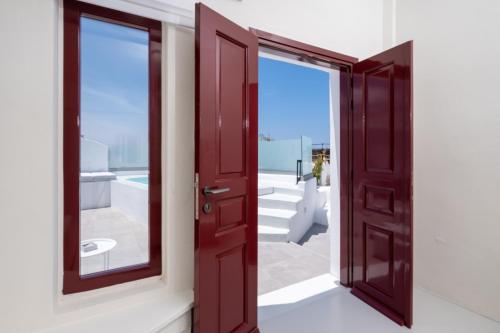 an open door with a view of the ocean at OUTOPOIA CAVE STUDIOS in Oia