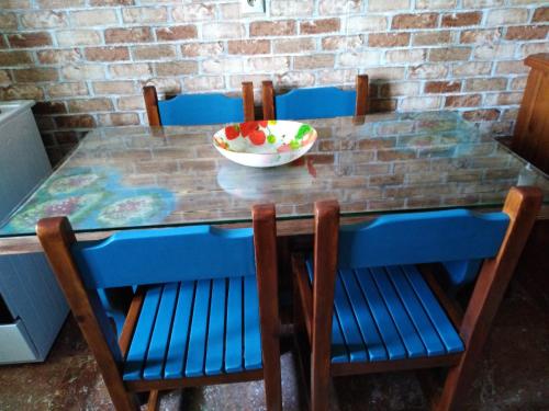 a table with chairs and a bowl of fruit on it at Teo & Niki in Paleokastritsa