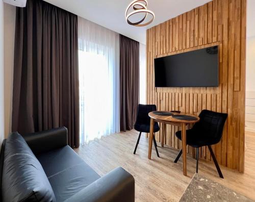 a living room with a couch and a table at TideHaven in Palanga