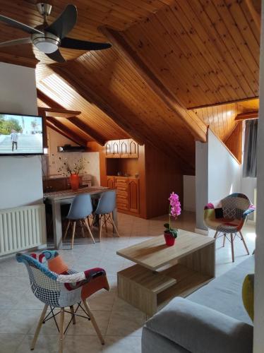 a living room with a ceiling fan and a table at D&K Studio in Myrina