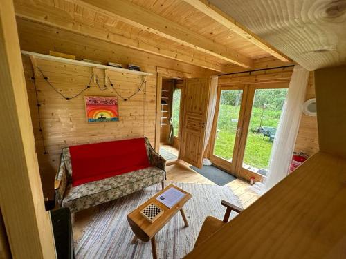 a living room with a couch in a log cabin at Raistiko Talu- Farmhouse, off-grid cabin and more 