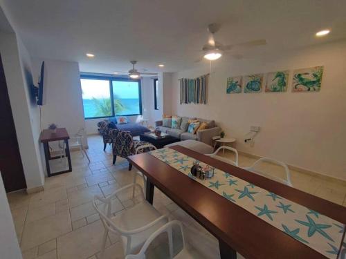 sala de estar con sofá, mesa y sillas en Puerta al mar, en Cancún